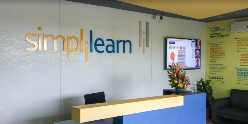 A Business Development Associate at Simplilearn discussing sales strategies in an office setting.